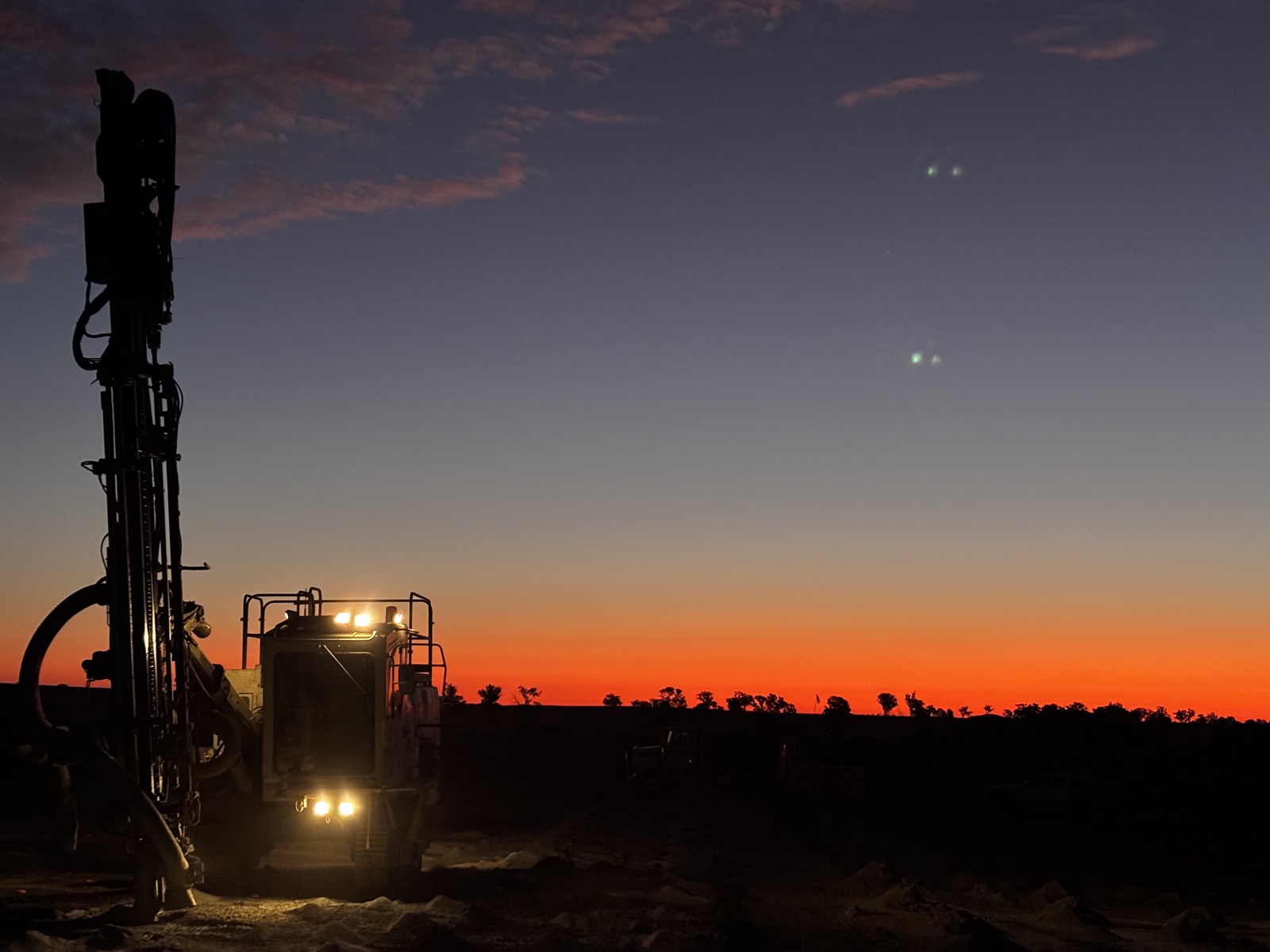 Drill rig at first light under a pink sky