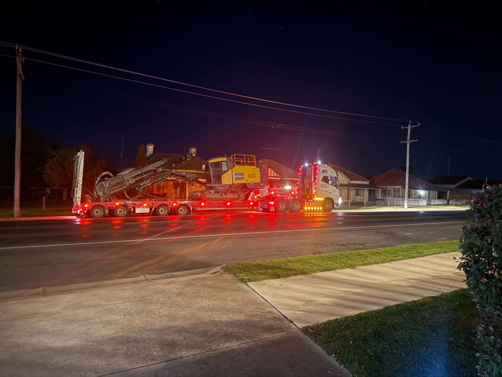 SES float convoy moving a rig through town at night