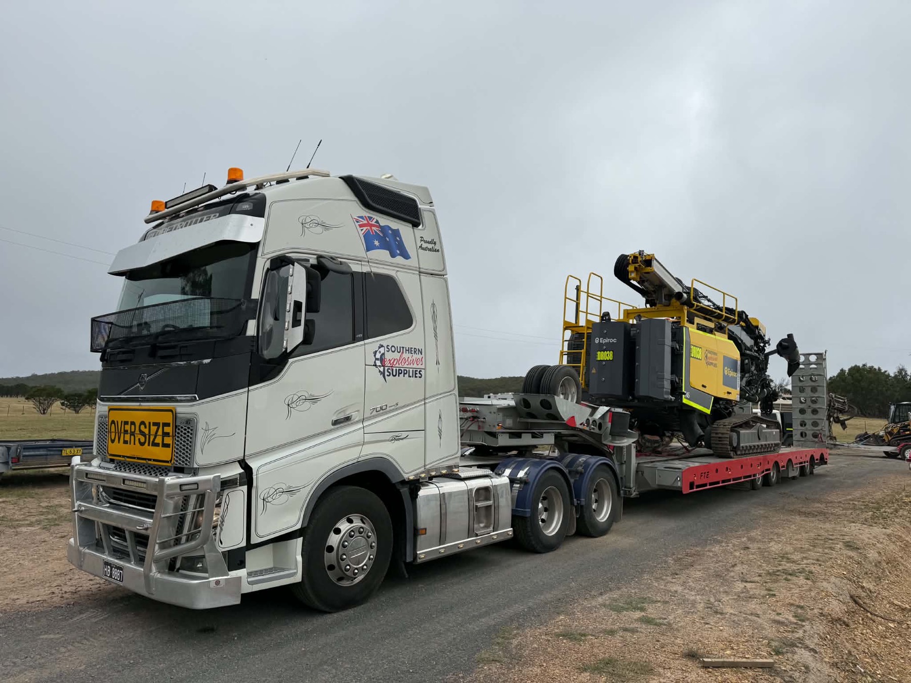 SES prime mover and low loader carrying a drill rig